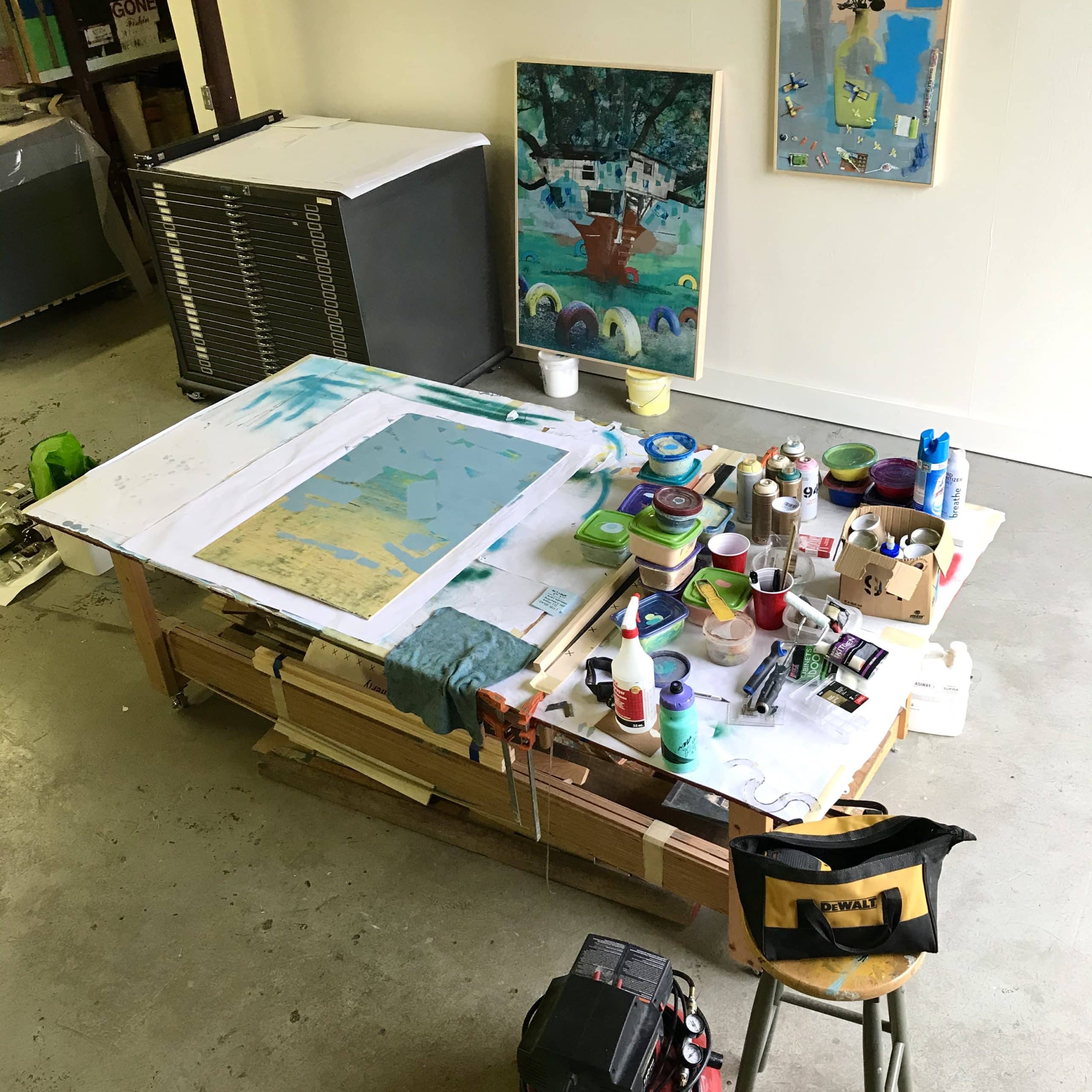 Bright artist studio with sketch easel and shelves