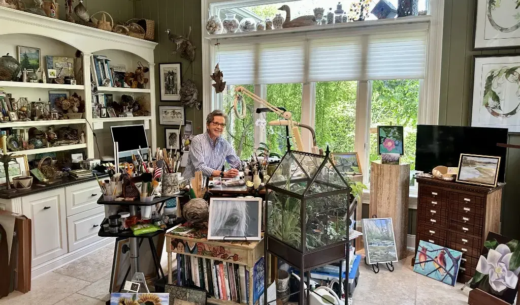 Bright artist studio with sketch easel and shelves