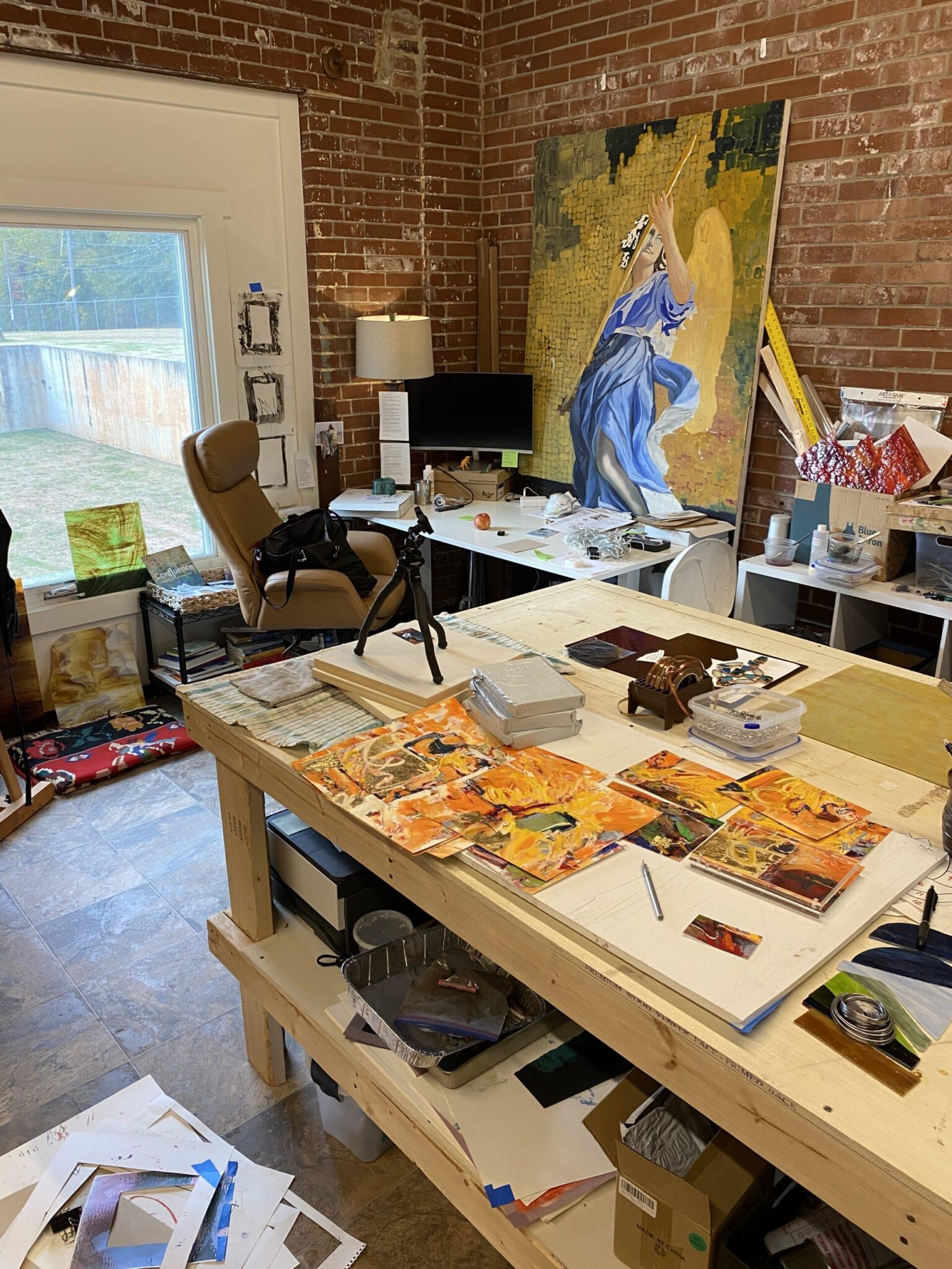 Bright artist studio with sketch easel and shelves