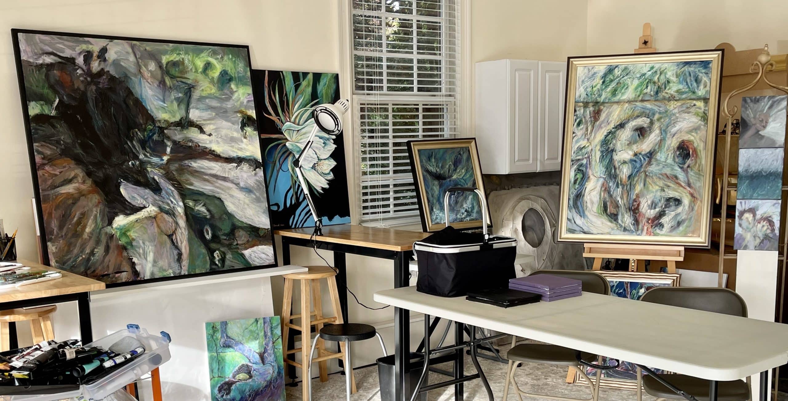 Bright artist studio with sketch easel and shelves